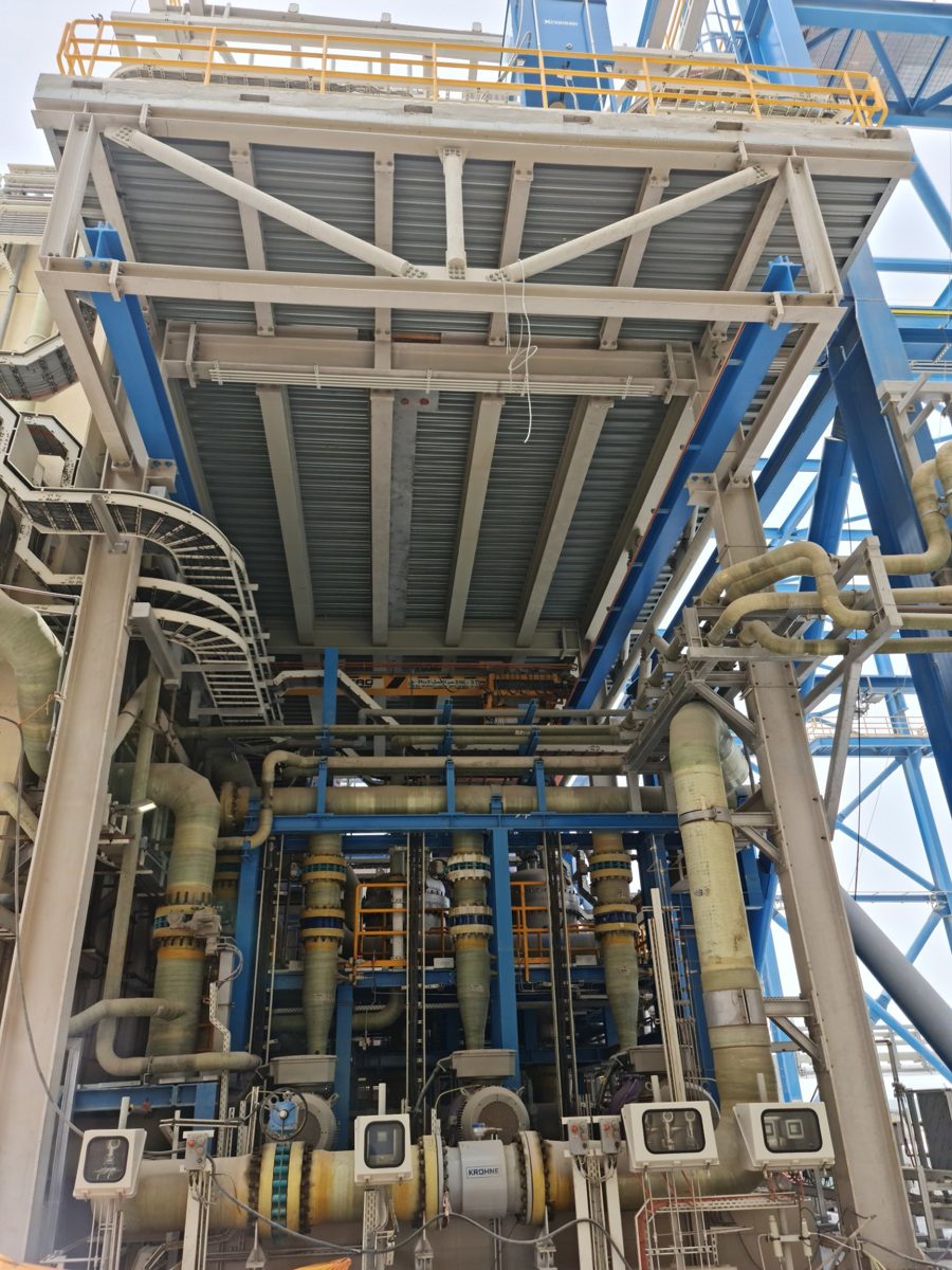 Industrial plant with coated steel platform, blue structural steel and fibreglass piping
